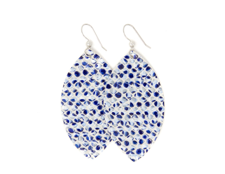 A pair of blue and white leather earrings with a leaf pattern, attached to silver hooks.
